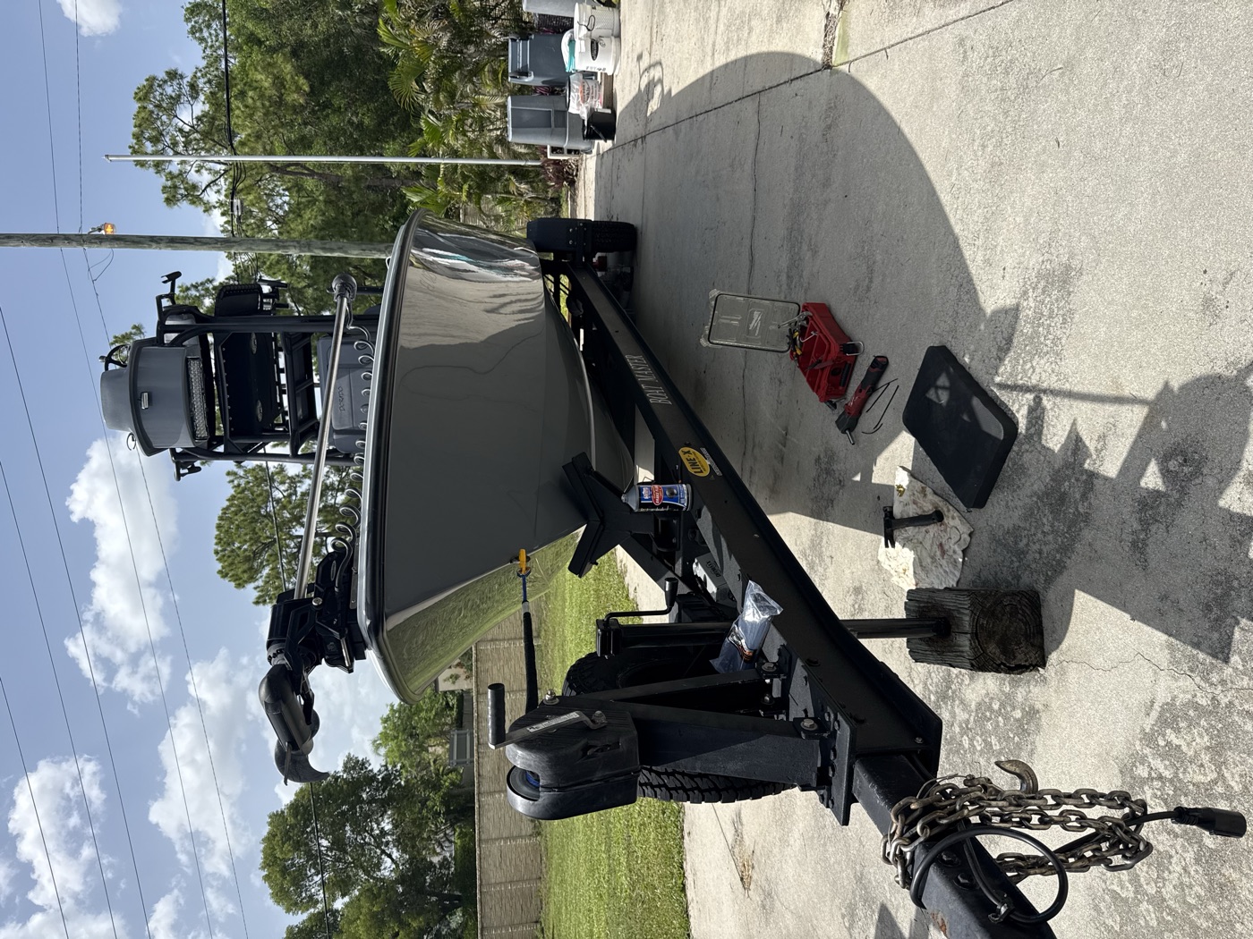 Trailer service in progress on a Boat Master trailer, tools laid out at the tongue