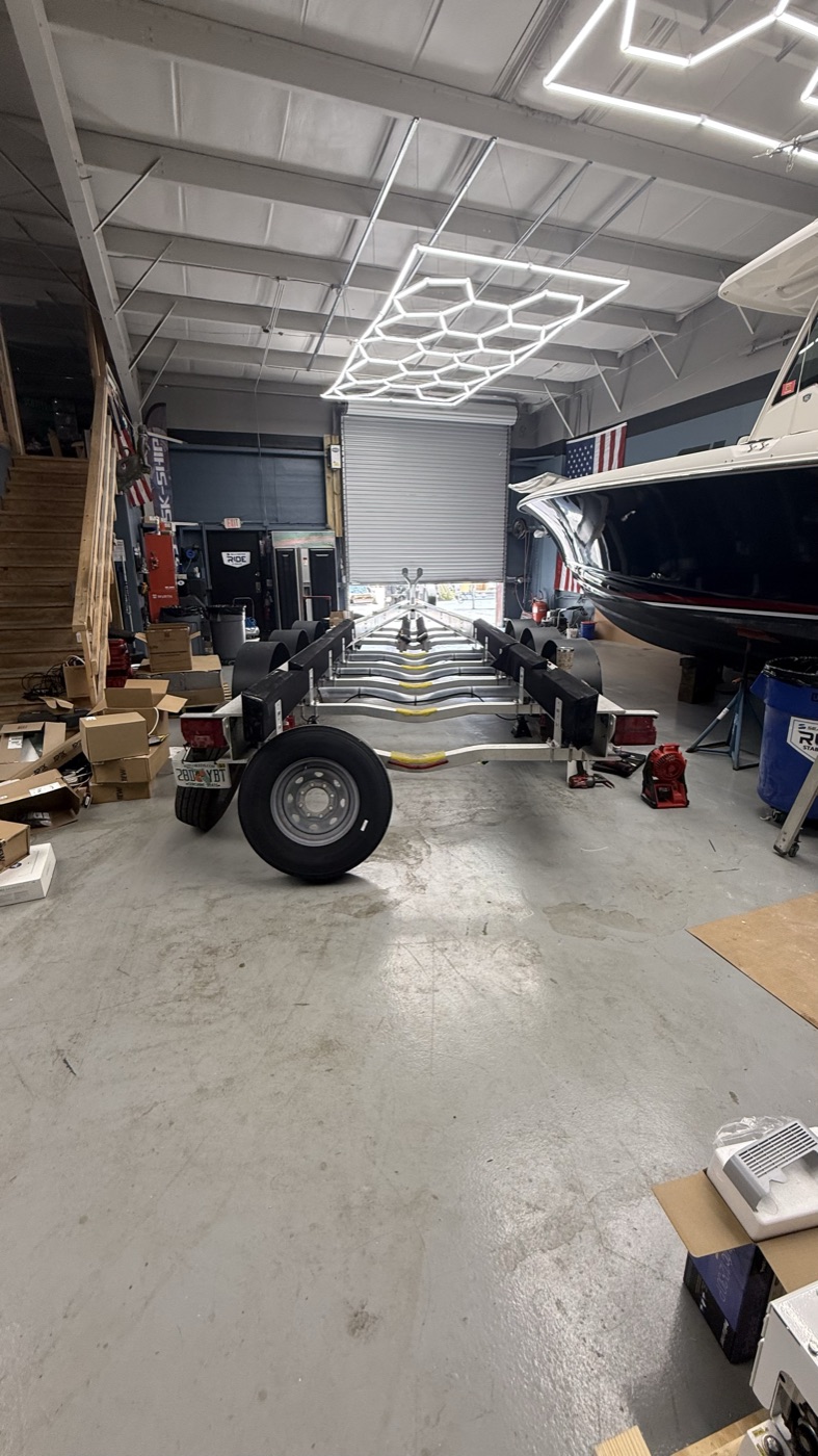 Aluminum tandem-axle boat trailer being serviced in a shop