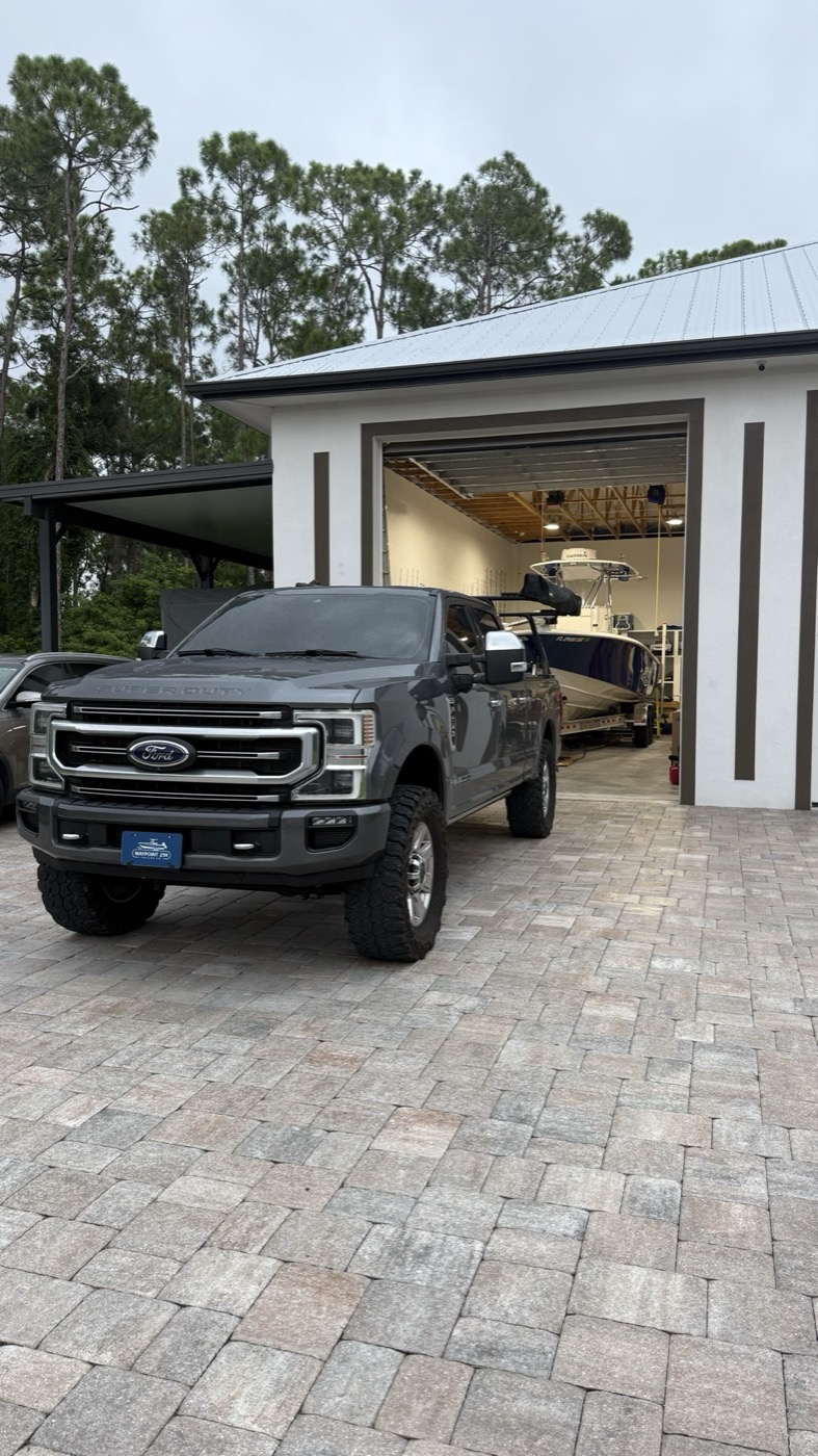 Waypoint 239 truck in front of a boat garage with a center console on its trailer