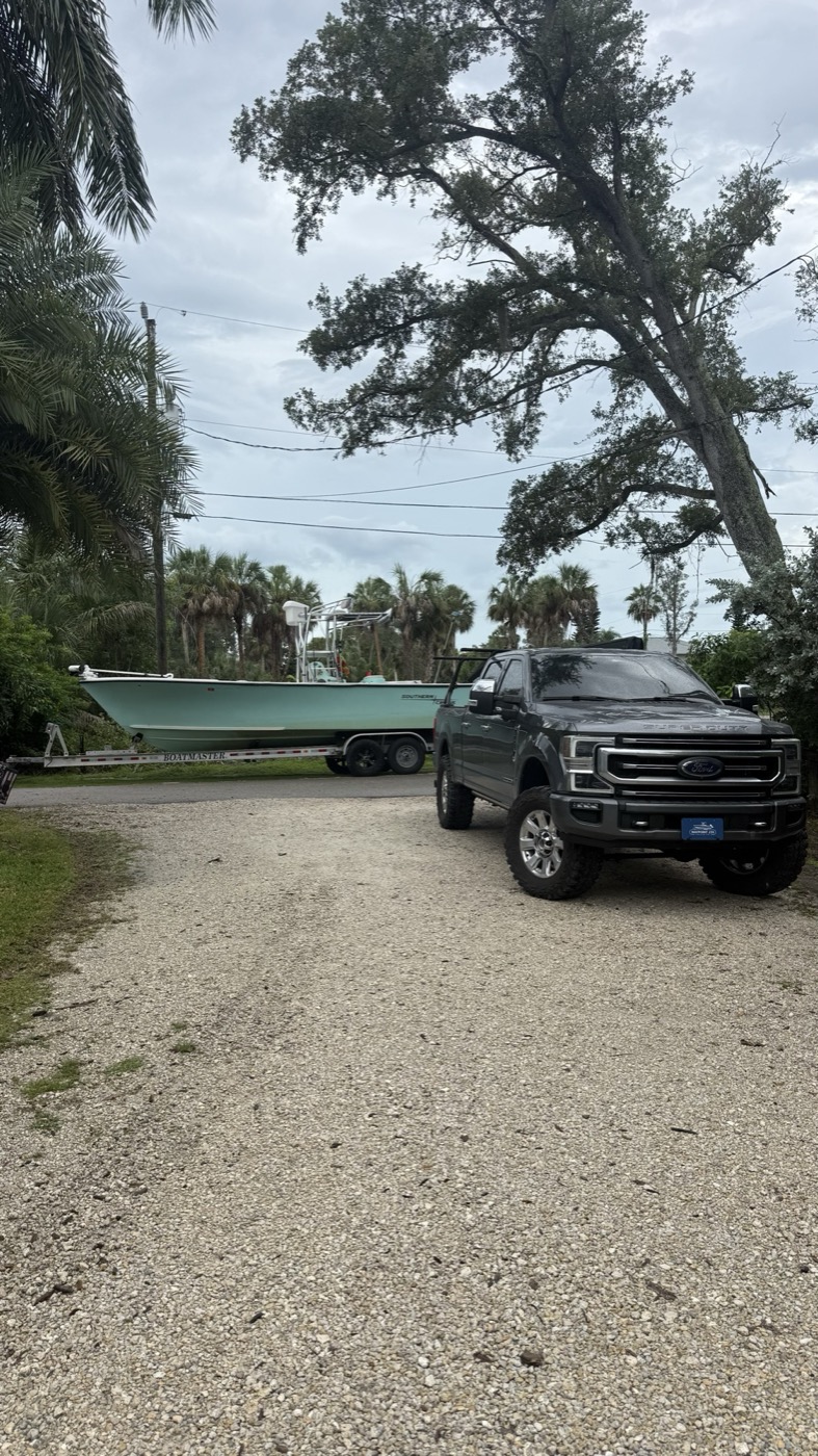 Waypoint 239 truck towing a seafoam center console on a tandem-axle trailer