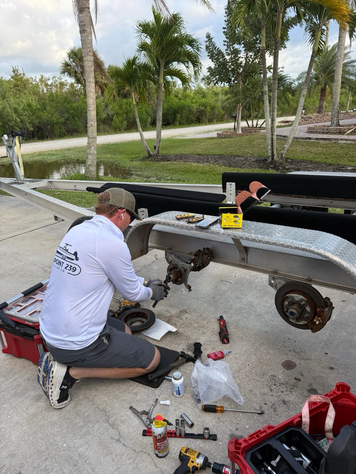 Waypoint 239 technician servicing a boat trailer's hub and brakes on-site